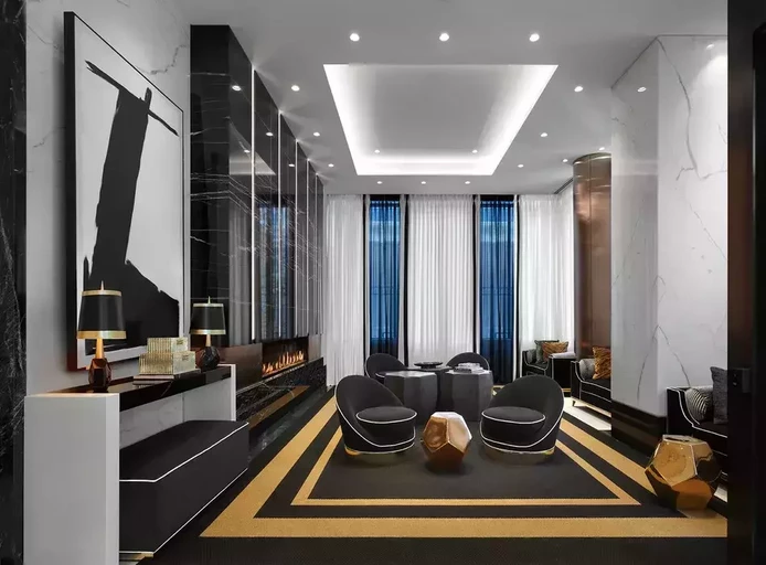 Luxury Midtown Toronto grand Lobby Lounge with elegant fireplace and plush, black seating.