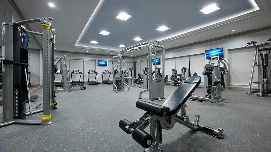 Fully equipped state-of-the-art fitness centre with with cardio machines and weights in North Toronto apartment.