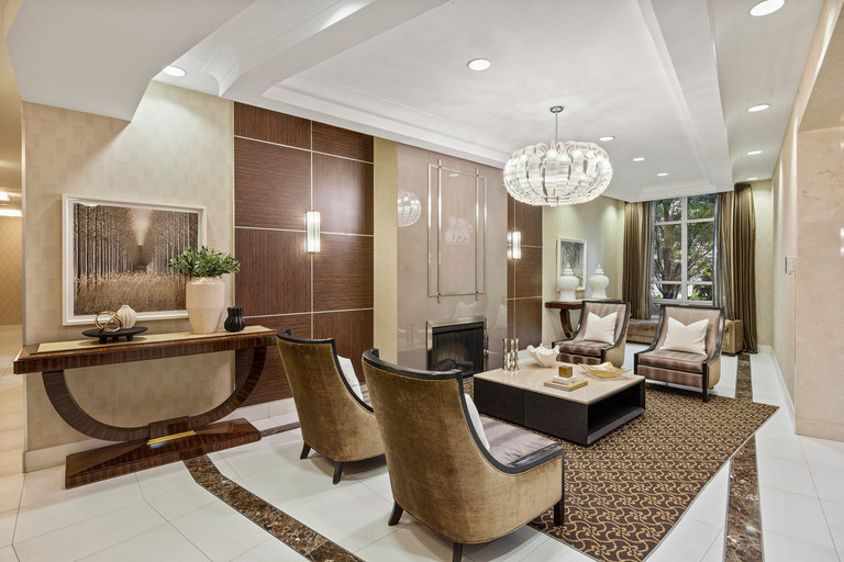 2-Storey fireplace lobby lounge with beige seating and large window at Yonge and Sheppard