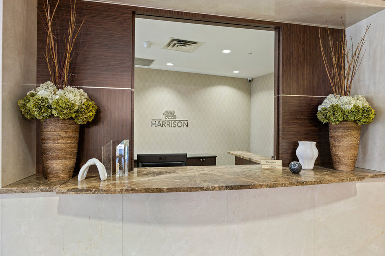 Concierge desk with 24/7 security, resident support and onsite property management services at 105 Harrison Garden Blvd.