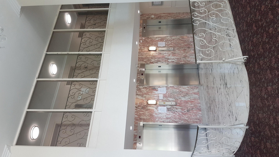 2-Storey lobby vestibule with 3 silver elevators and pink marble wall at 35 Canyon Ave