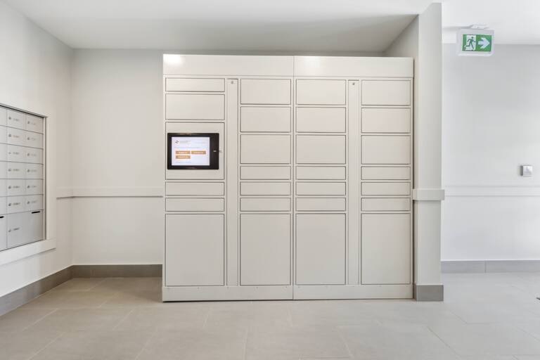 A white door with a screen on it is in a room.