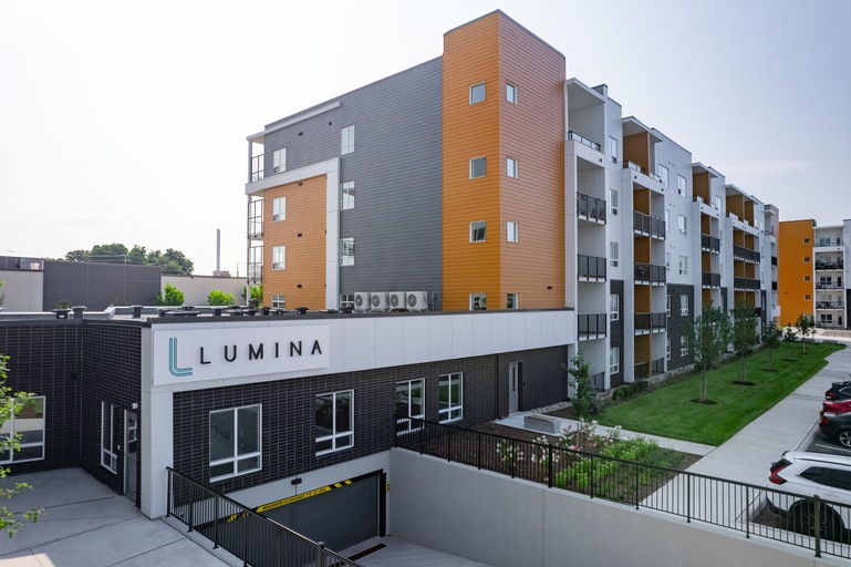 A modern apartment complex named Lumina is shown in the image.