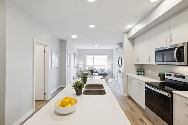 A modern kitchen with a bowl of lemons on the counter.
