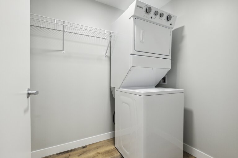 A white oven and dryer in a small room.