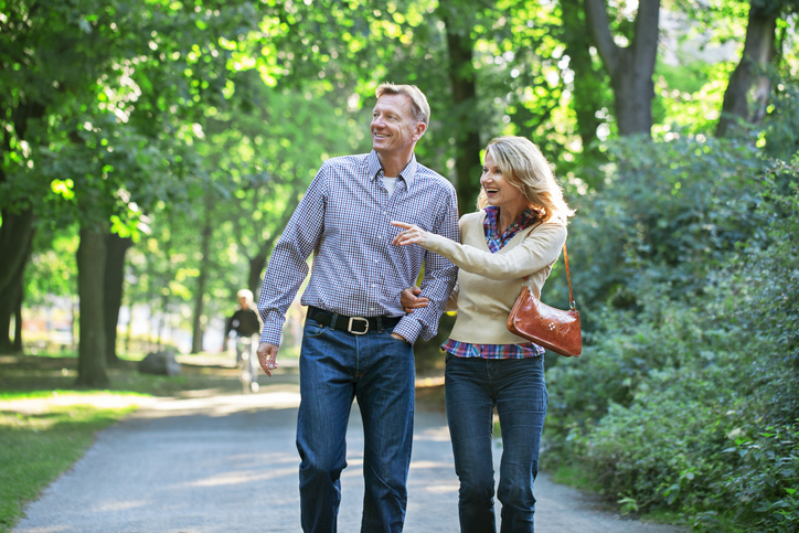 Couple walking through a park