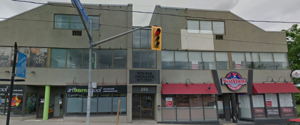Toronto apartment building entrance at 250 Eglinton Avenue West including stores on both sides.