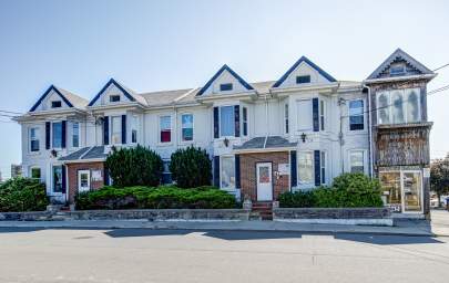 Guelph apartment building entrance at 45-49 Surrey Street East including surrounding greenery and street access.