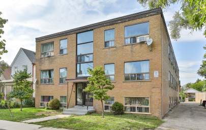 Toronto apartment building entrance at 8 Hector Avenue featuring building-front greenspace and outdoor parking.
