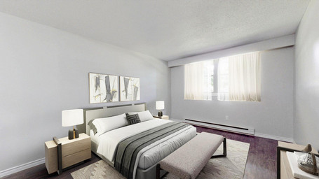 Virtually staged Belleville apartment with spacious bedroom at 245-255 Yeomans Street North featuring hard surface flooring and bright windows.
