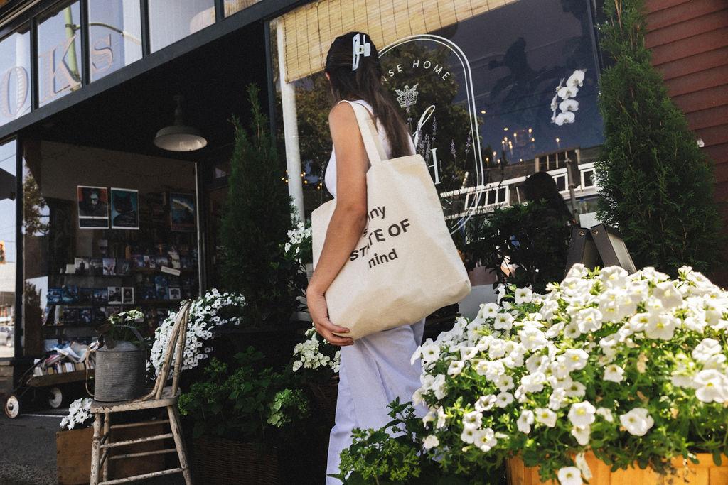 Two people on a park bench looking out over a lake with mountains in the background and a ship on the lake.