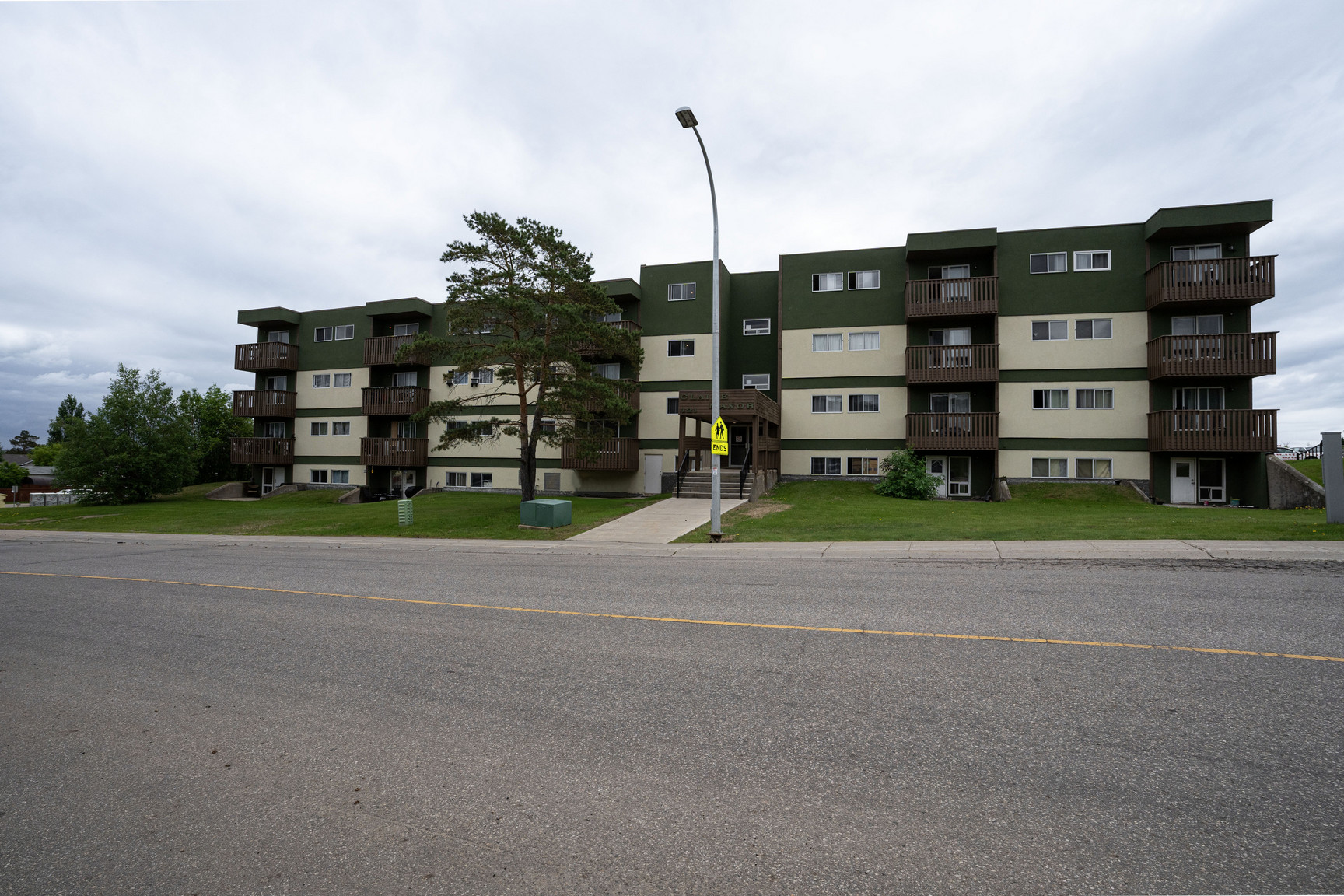 Claire Manor residential apartment building and parking lot in a Fort McMurray neighborhood