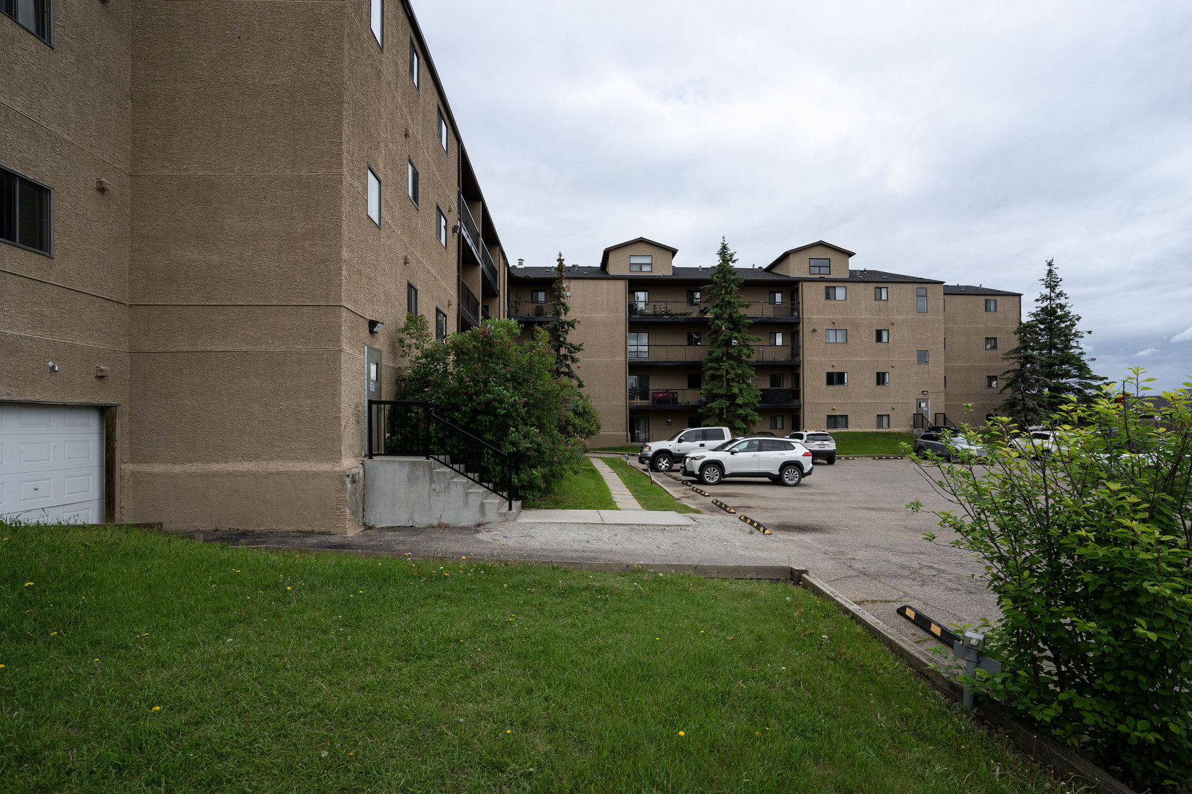 Front entryway and multi-level balconies of the Rosedale Court apartment complex in Fort McMurray