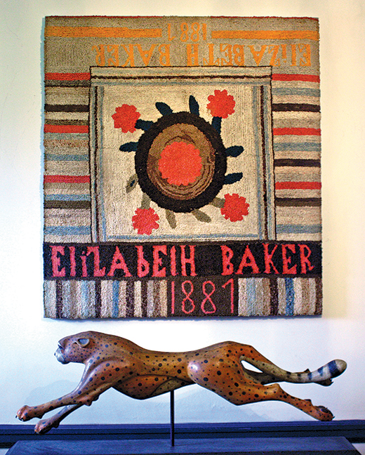 Large colorful Adams County, Pennsylvania hooked table rug.  Elizabeth Baker, 1881. Professionally mounted. 45” high, 42” wide.  Fine carved cheetah by William “Old School Willie” Kennedy,  award winning folk artist and carver from South Lake, Texas, born 1947. 43” long.