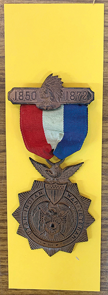 A medal issued in 1906 to Henry Judson McCullough (1842-1911), a “Utah Indian War Veteran,” who also happened to be a Mormon pioneer, sold with its original red, white, and blue ribbon intact for $1950 (est. $1500/2500). The total length of the item, from the top of its crossbar to the bottom of its sunburst design, is 4