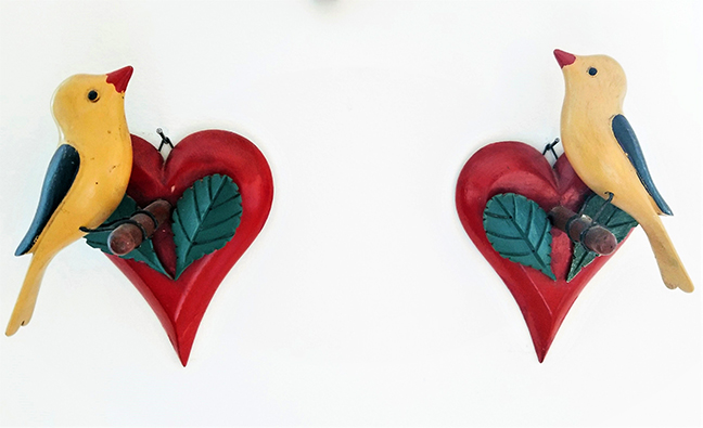 A rare pair of carved Finches on Red Hearts. Attributed to Bedford County, Pa. C. 1920. In very good original condition with one green leaf refreshed. Each bird has the original wire hangers.