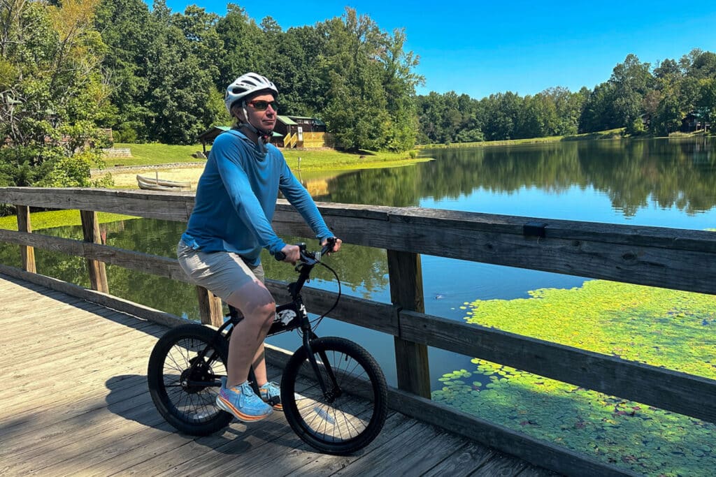 Woman riding JackRabbit micro ebike on bridge