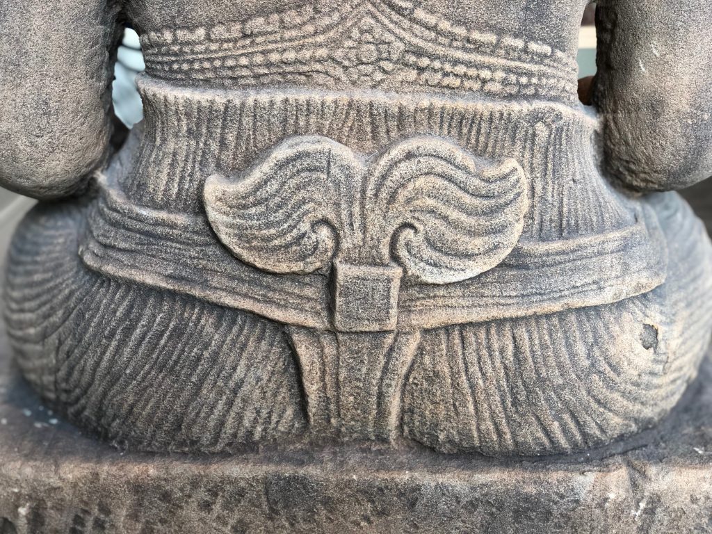 Photograph of a close-up detail from a sculpture depicting a Hindu deity