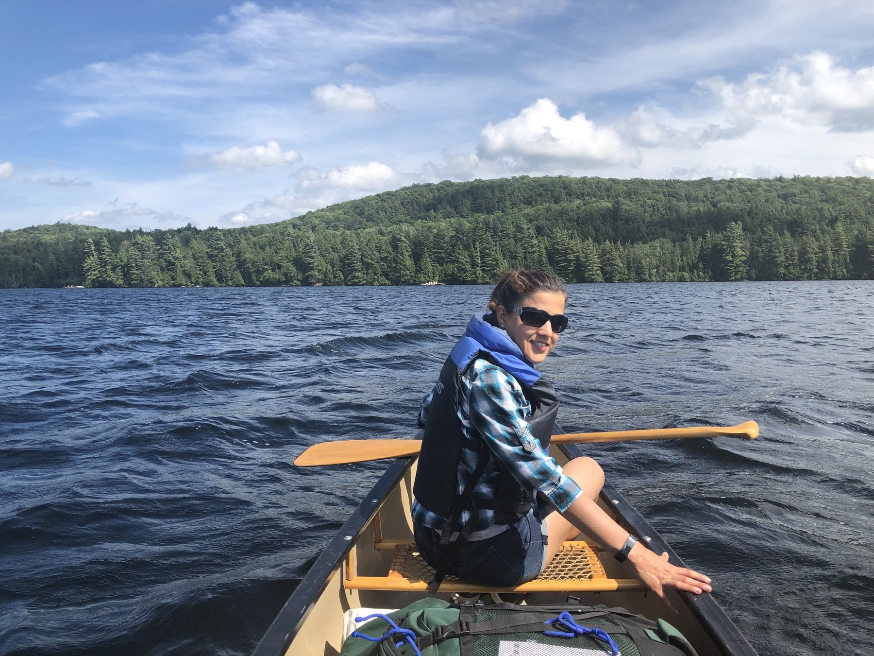 Juliana Borba in a canoe on a lake