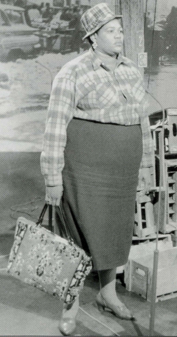 In a black-and-white photo on the right of the slide, Big Mama Thornton stands on a stage in a dark skirt and matching plaid hat and button-up shirt (seemingly the same from slide 7). She is holding a floral purse and gazing off to the right of the photo.