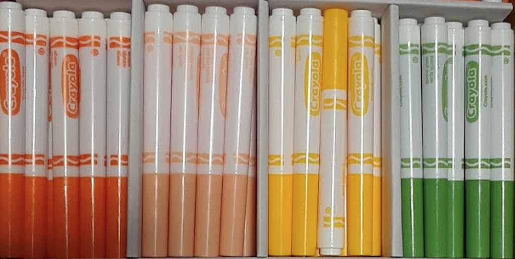 A photograph of red, orange, yellow, and green markers.