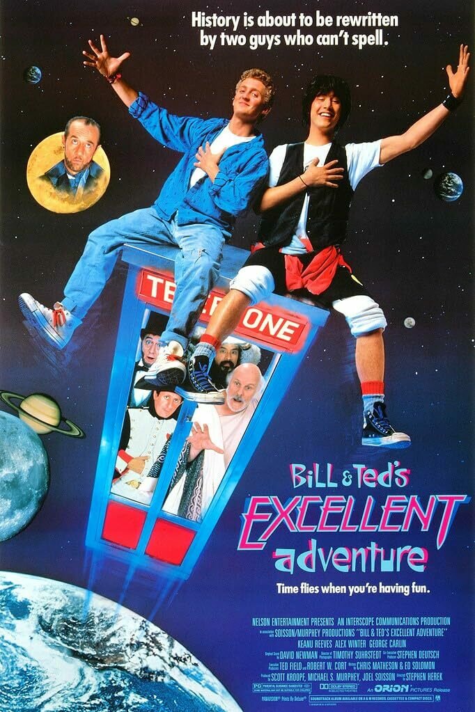 Cover art of Bill & Ted's Excellent Adventure. Two 80s teens are sitting on top of a time travelling phone box flying through space. The phone box is filled with historical figures.