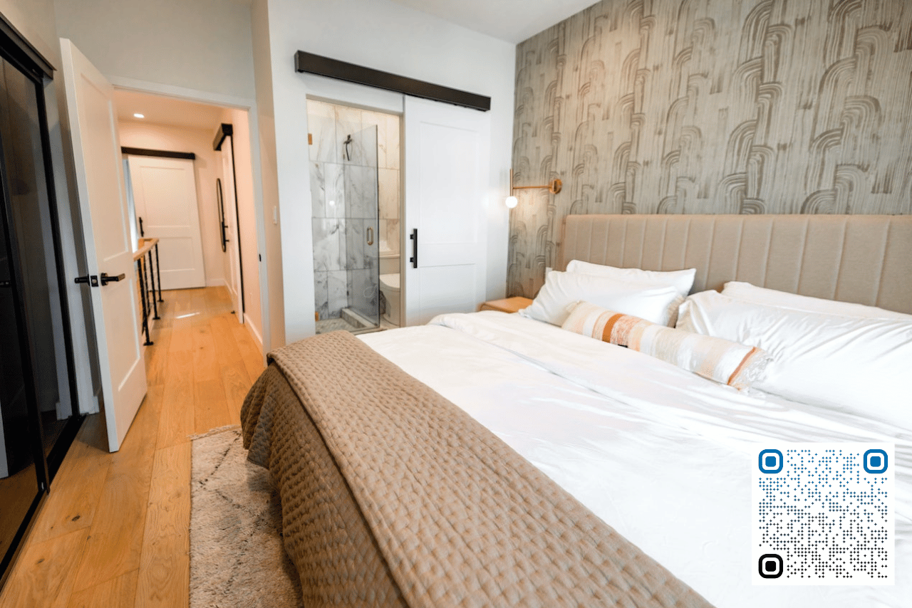 Airbnb bedroom with a shower in the background. Airbnbs with private rooms and showers have higher rental income potential