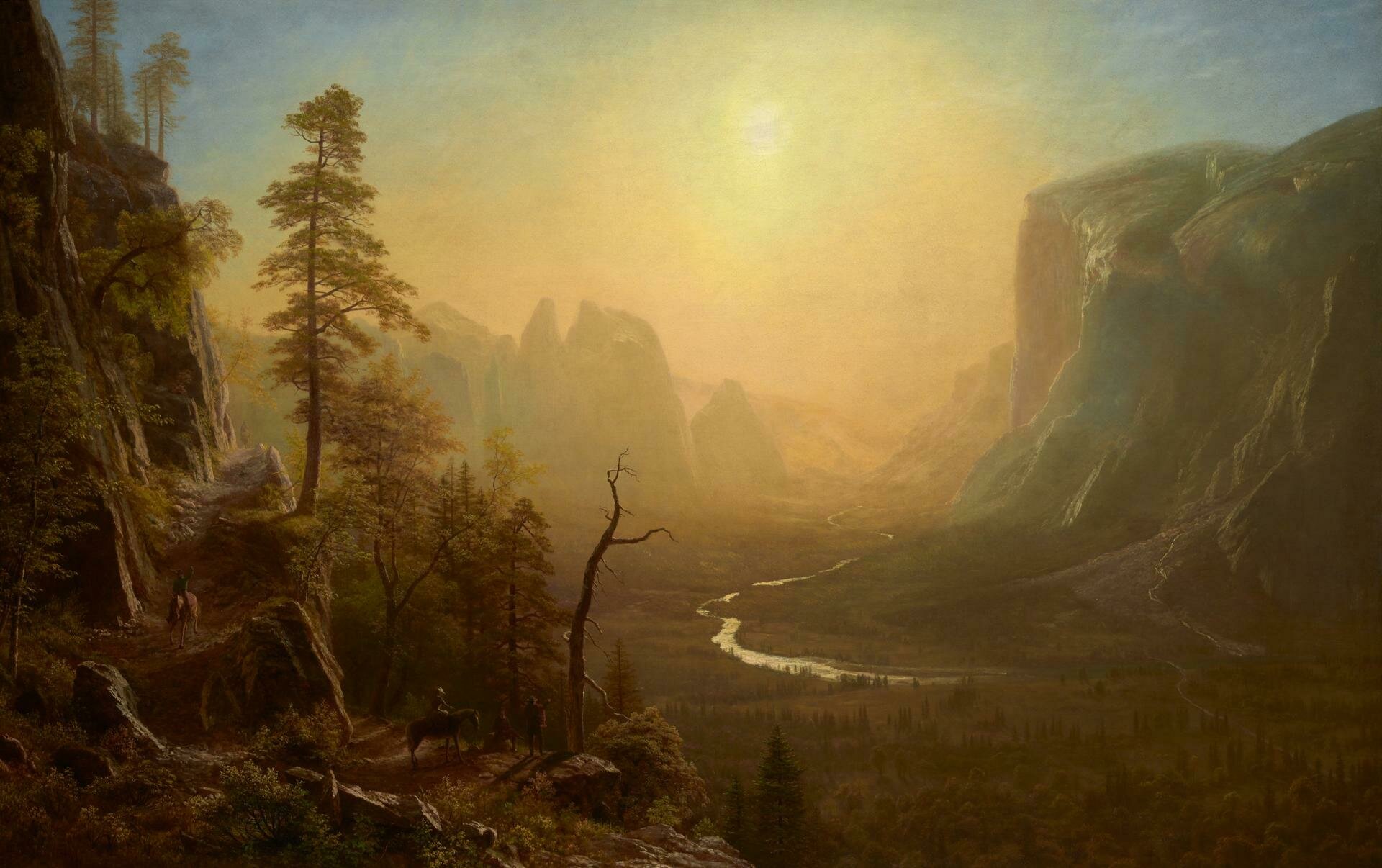 Pintura del artista Albert Bierstadt que captura la majestuosidad del paisaje del Oeste americano, probablemente una representación del Parque Nacional de Yosemite. La luz del sol filtra a través de un cielo brumoso, iluminando las montañas y valles con una calidad etérea. La obra de arte está imbuida con un sentido de la sublime grandeza de la naturaleza, una característica distintiva del estilo de Bierstadt y de la escuela del paisajismo americano conocida como Hudson River School. La composición incluye detalles minuciosos de la flora y la fauna, así como figuras humanas que proporcionan escala y una sensación de la presencia humana en el vasto entorno natural.