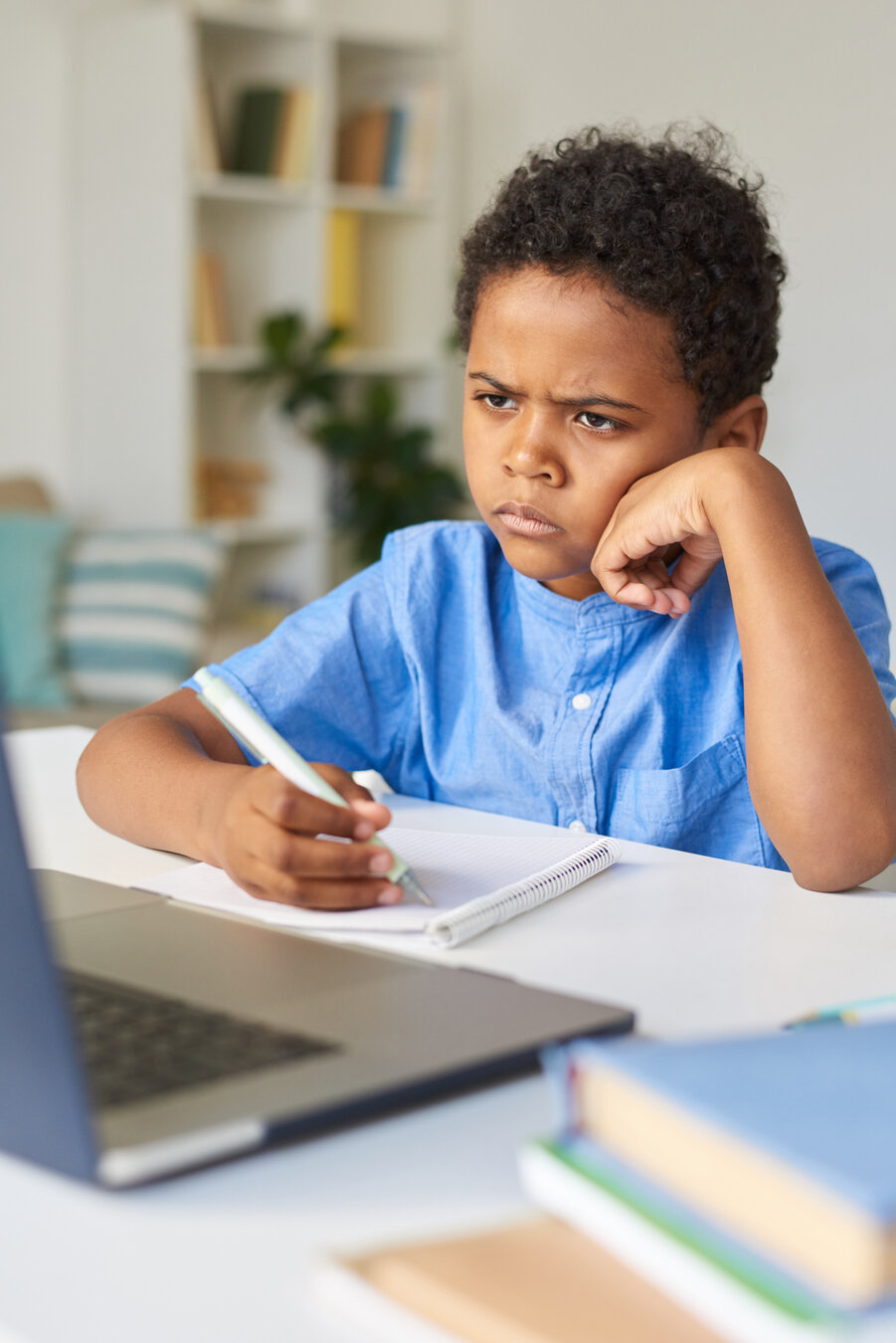 Student furrowing eyebrows while doing homework