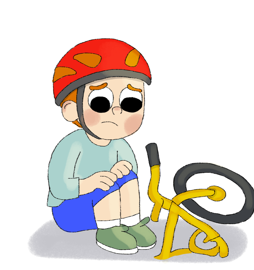 boy on ground next to bike