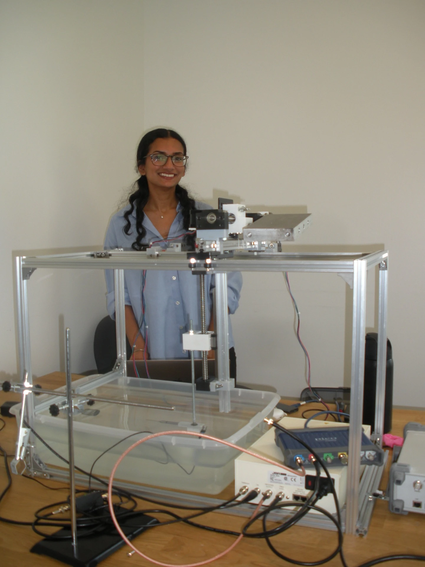 Avneet Bahra with the ultrasound acoustic-characterization tank and automated motion-control system
