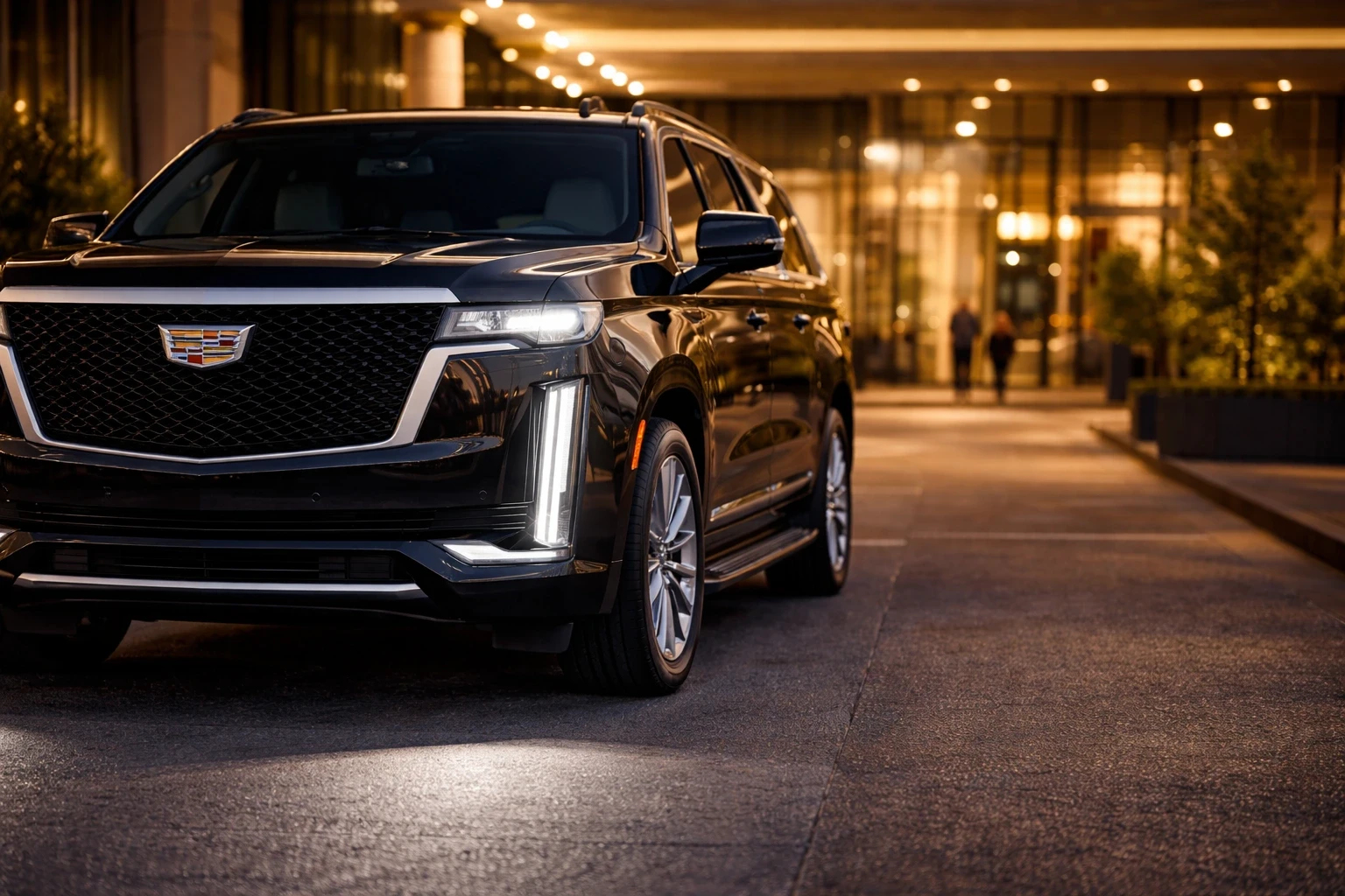 A commanding 2026 black Cadillac with vertical LED lighting and refined grille at night