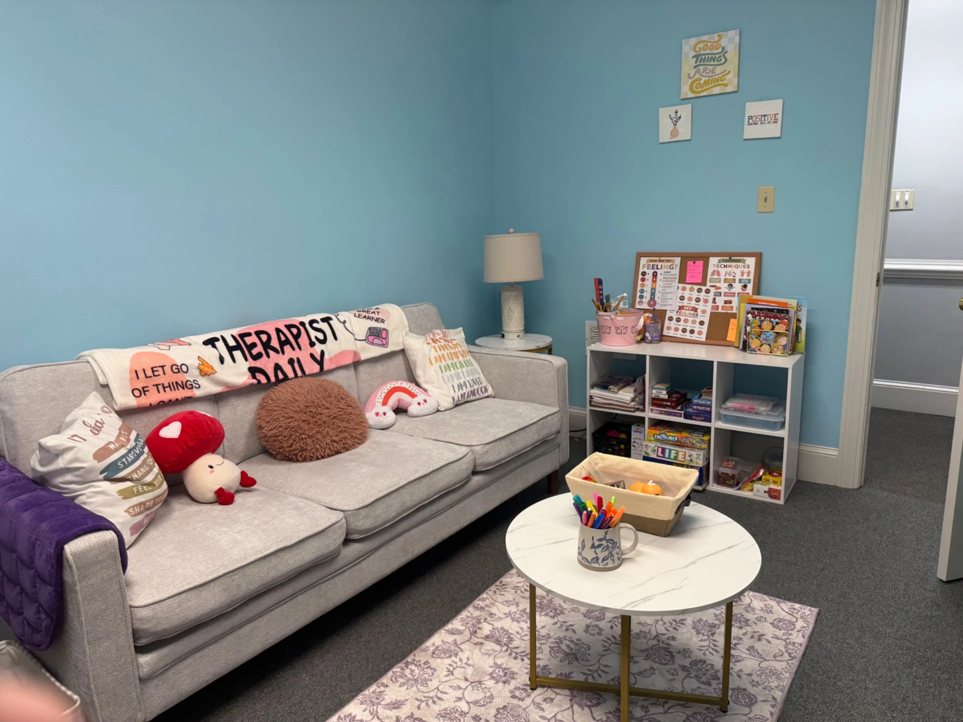 A warm, sunlit corner of a therapy room with a comfortable armchair and plants