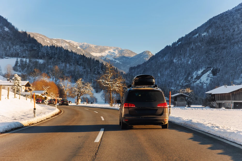 Premium transfer vehicle navigating a snowy mountain road