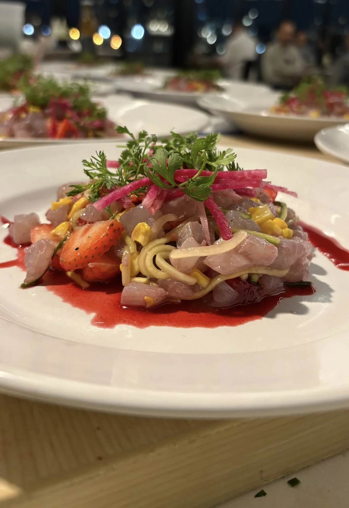 Overhead view of a private chef plating a multi-course gourmet dinner