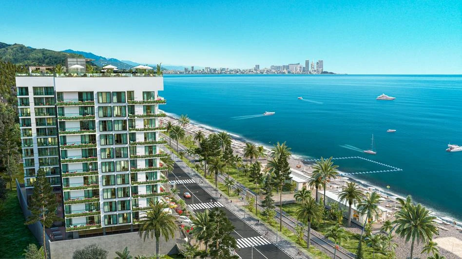 Novotel Living Batumi seafront tower with palms and the Black Sea