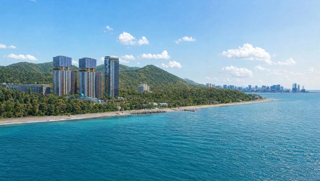 Towers on the Black Sea coast near Batumi with the city skyline in the distance
