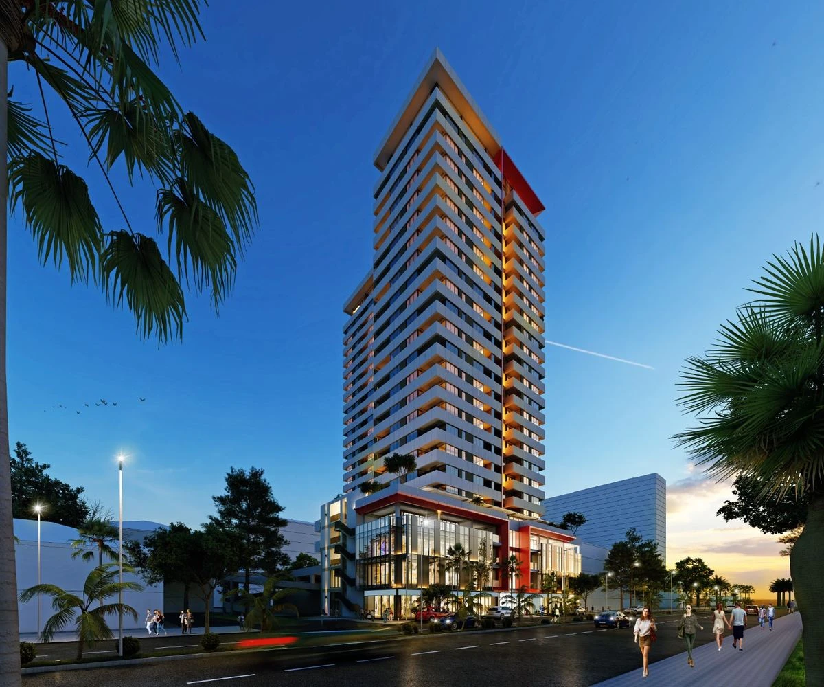 Mardi Stadium residential tower at dusk with shops at its base, Batumi
