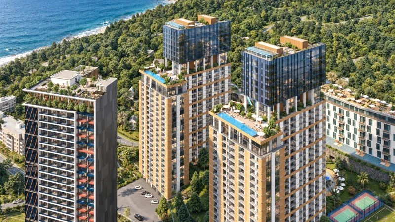 Aerial view of the Aqua Residence towers with rooftop pools beside the Black Sea coast