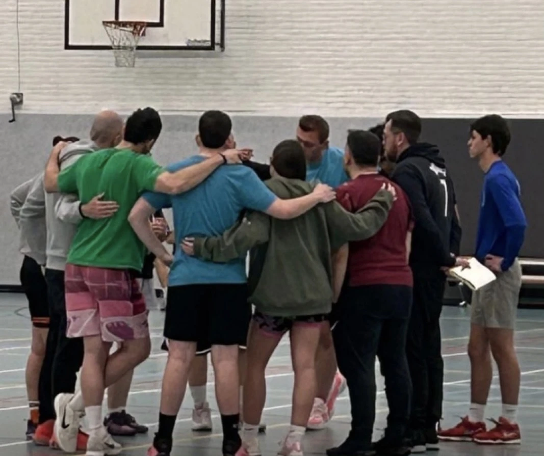 Professional coach instructing players during a clinic