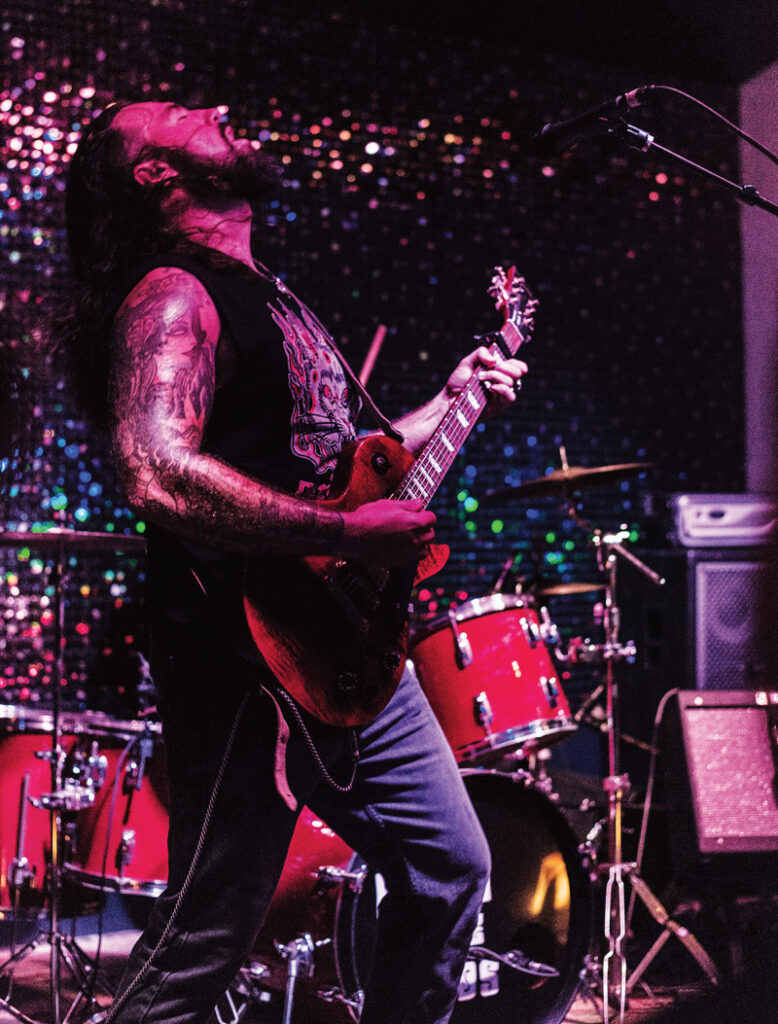 Theophile Bourgeois playing guitar live.