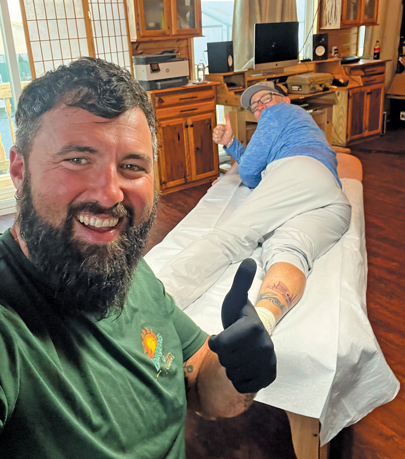 Theophile Bourgeois giving tattoo