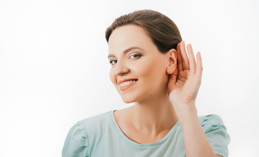 smiling hearing loss patient is struggling to hear properly