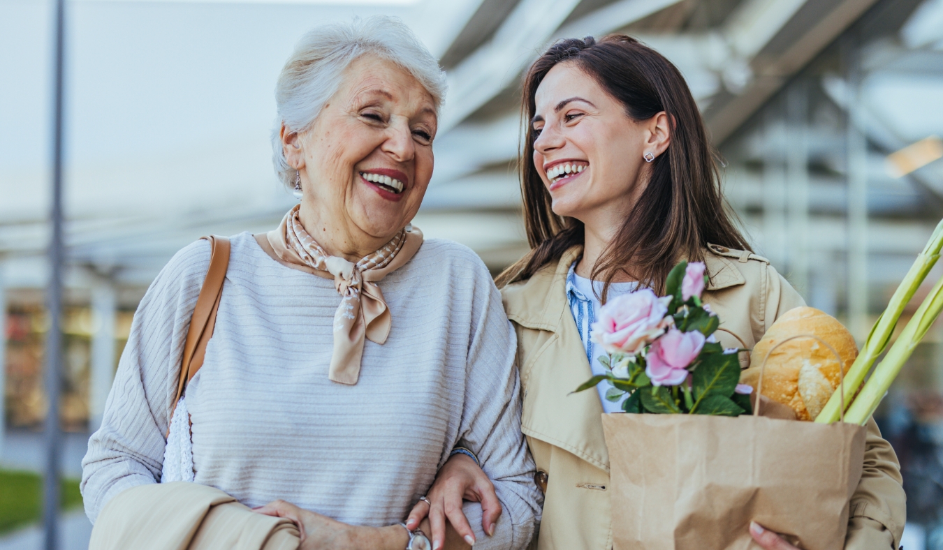 granddaughter and grandmother walking outdoors after shopping