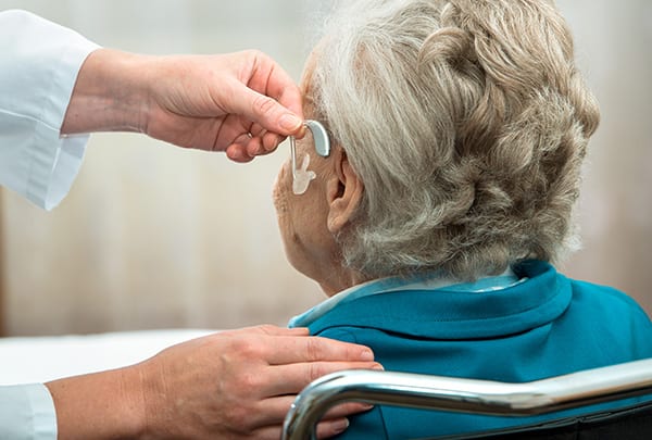 a hearing loss patient is having new hearing aids fitted