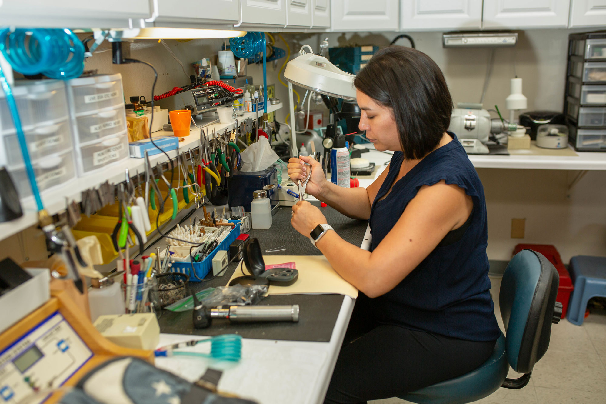 Jessica Cimolino performing hearing aid maintenace