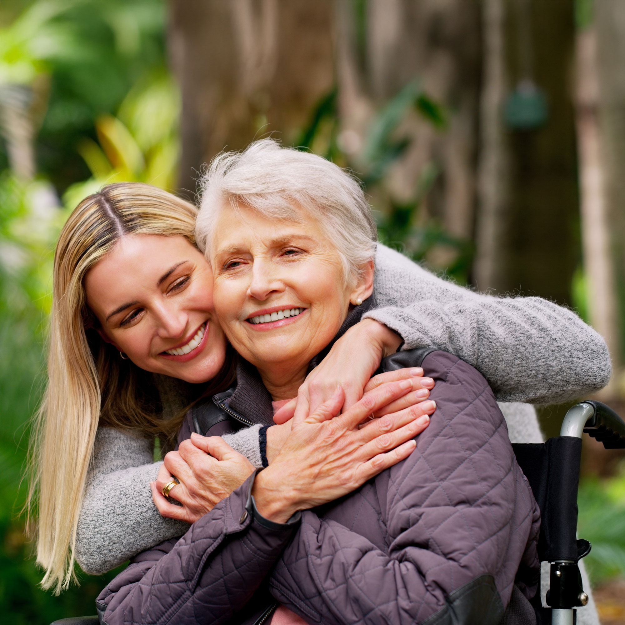 granddaughter hugging grandmother in wheelchair