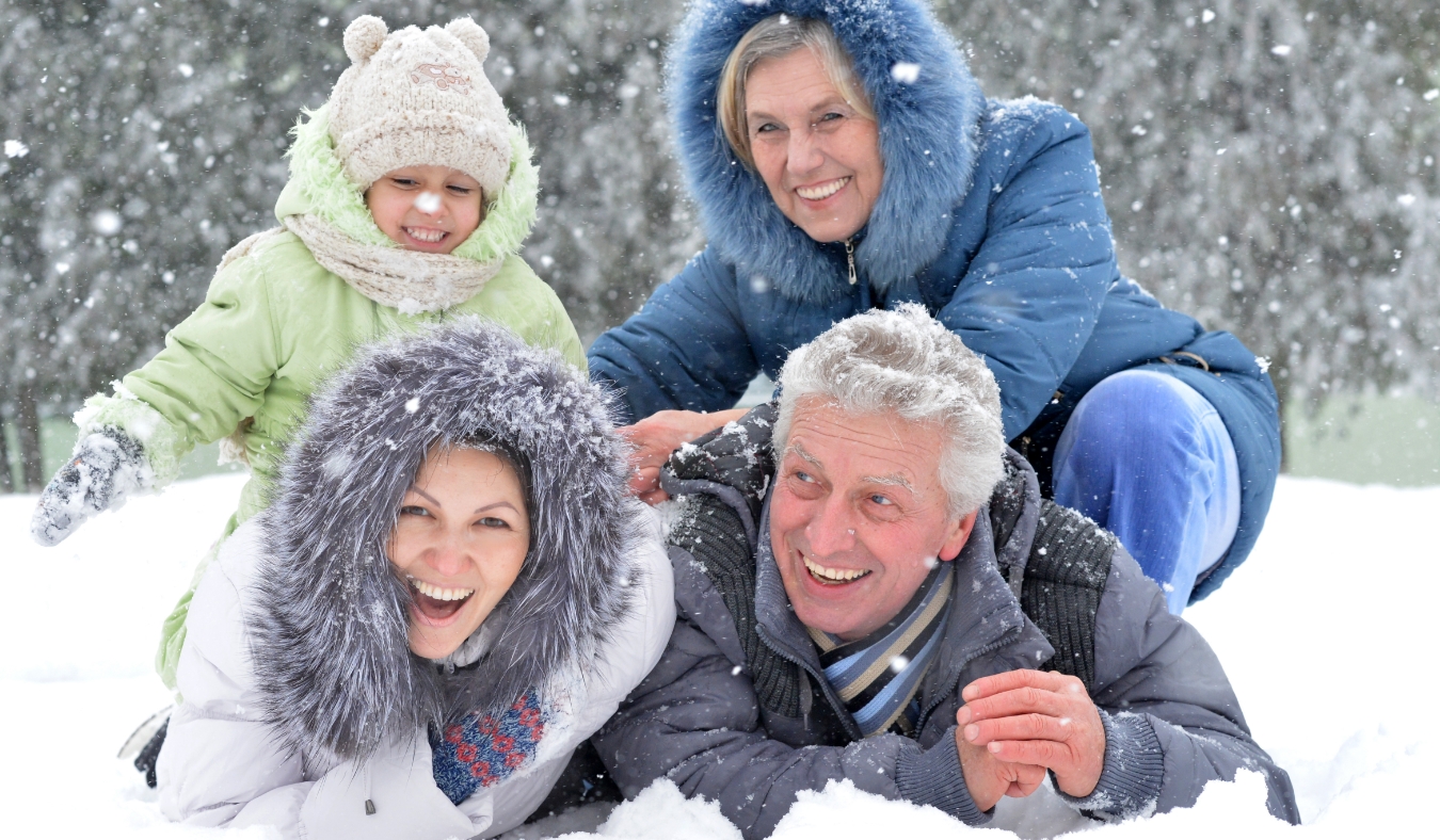 grandparents and grandchildren playing in snow