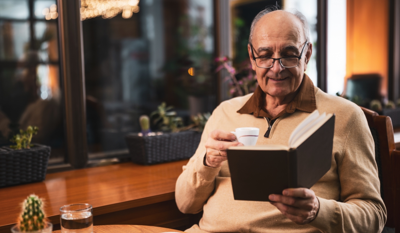 man reading in a cozy cafe with espresso