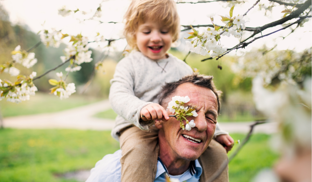 spring son on grandfather soldier enjoying spring blossoms